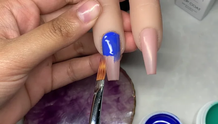 Use the tip of the ombre brush with light pressure to feather the second color down from the top, creating an ombre effect.