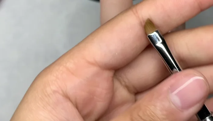 Use the angled liner brush dipped in acetone to clean up any mistakes.