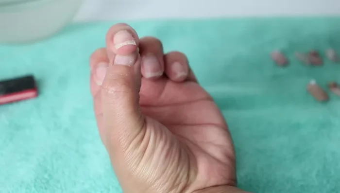 Use a Q-tip with acetone to flatten any remaining glue.