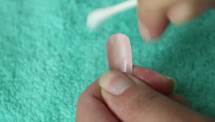 Use a Q-tip with acetone to flatten any remaining glue.