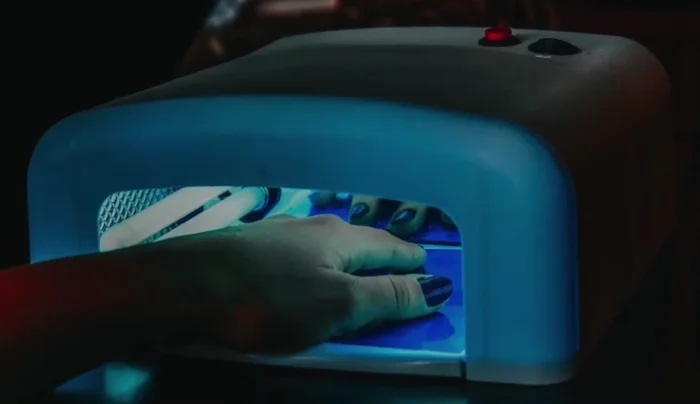 Invest in a smaller UV/LED lamp that only requires you to place your fingertips under the light.