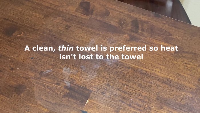 Place a towel over the stained area to protect the wood.