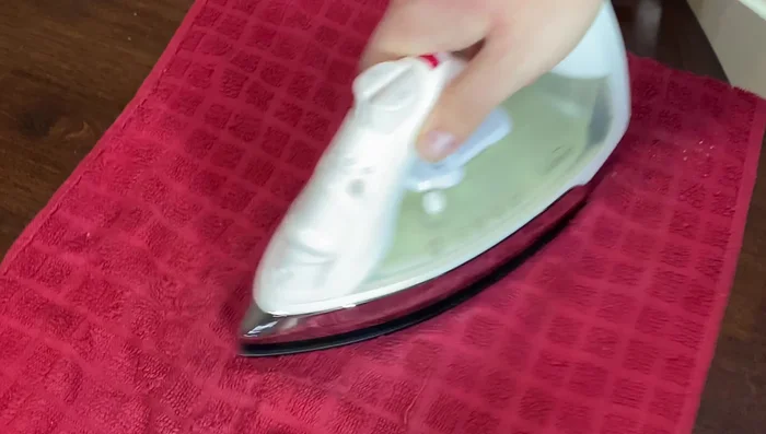 Continue ironing until the stain disappears. Repeat as necessary, keeping the iron moving.