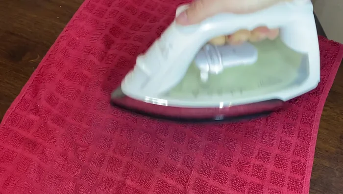 Continue ironing until the stain disappears. Repeat as necessary, keeping the iron moving.