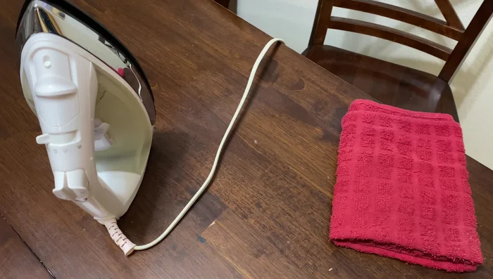 Continue ironing until the stain disappears. Repeat as necessary, keeping the iron moving.