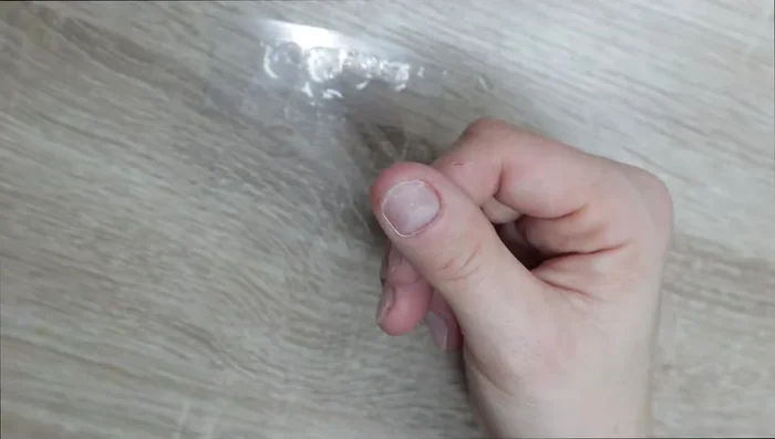 Use tweezers to ensure sticky tabs are pressed flat against the nails.