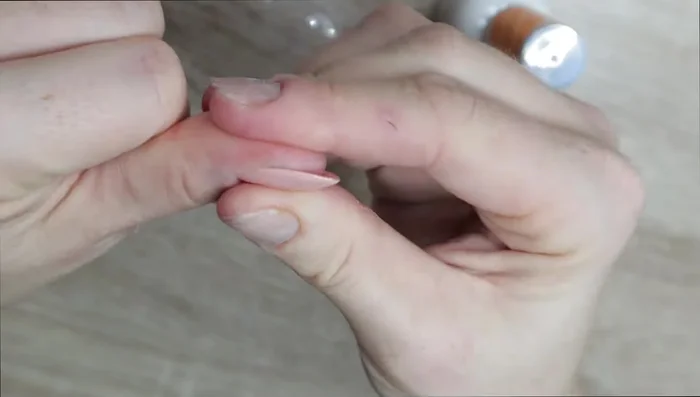 Apply the press-on nail, starting at the cuticle and pressing firmly.