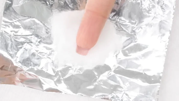 Wrap your finger in aluminum foil, ensuring no air gets in.