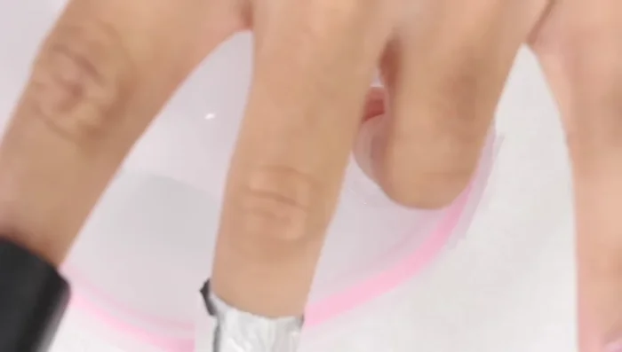 Submerge your nails in the acetone, rubbing against the cotton balls to remove the softened powder.