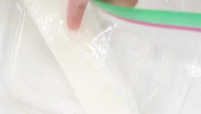 Place the baggie in a bowl of hot water and rub your finger against the paper towel to remove softened dip powder.