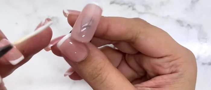Create a small curve from the sides of the straight line to form the French tip.