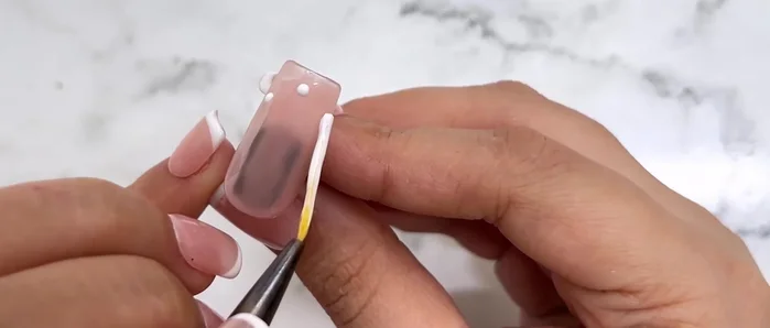 Use a dotting tool to create a series of dots along your desired smile line.