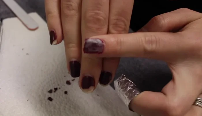 Use a nail file to lightly buff any stubborn shellac residue.