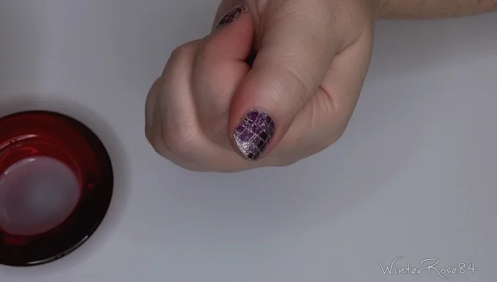 Rub the brush along the nail to dissolve the adhesive and peel off the wrap.