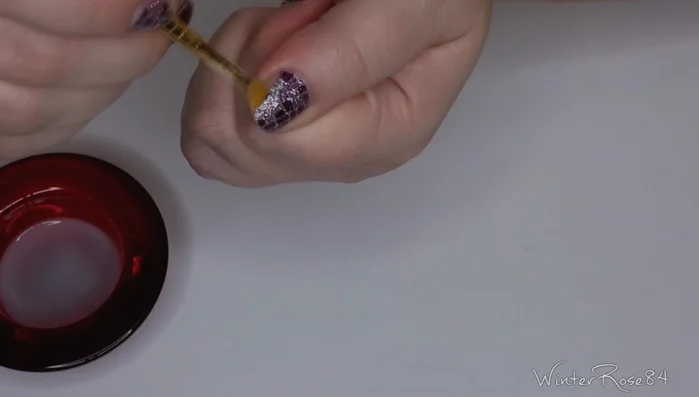 Rub the brush along the nail to dissolve the adhesive and peel off the wrap.