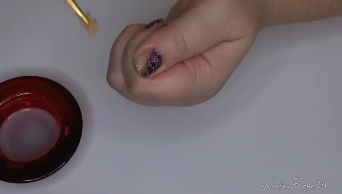 Clean the nail bed with nail polish remover.