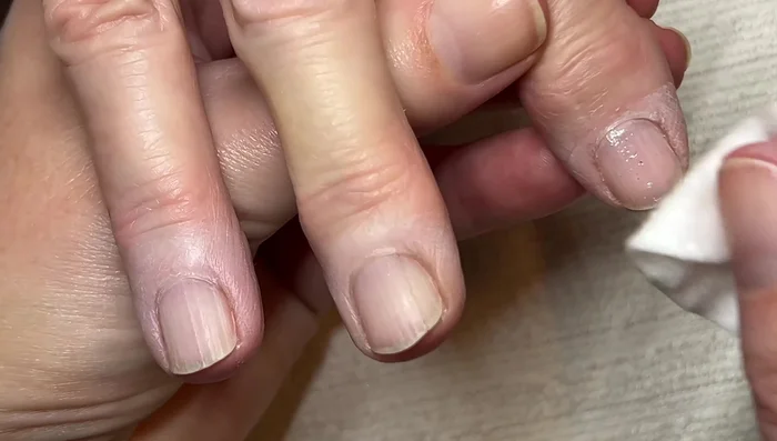 Gently clean under nails with a wooden stick
