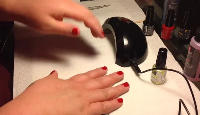 UV lamp curing red nail polish