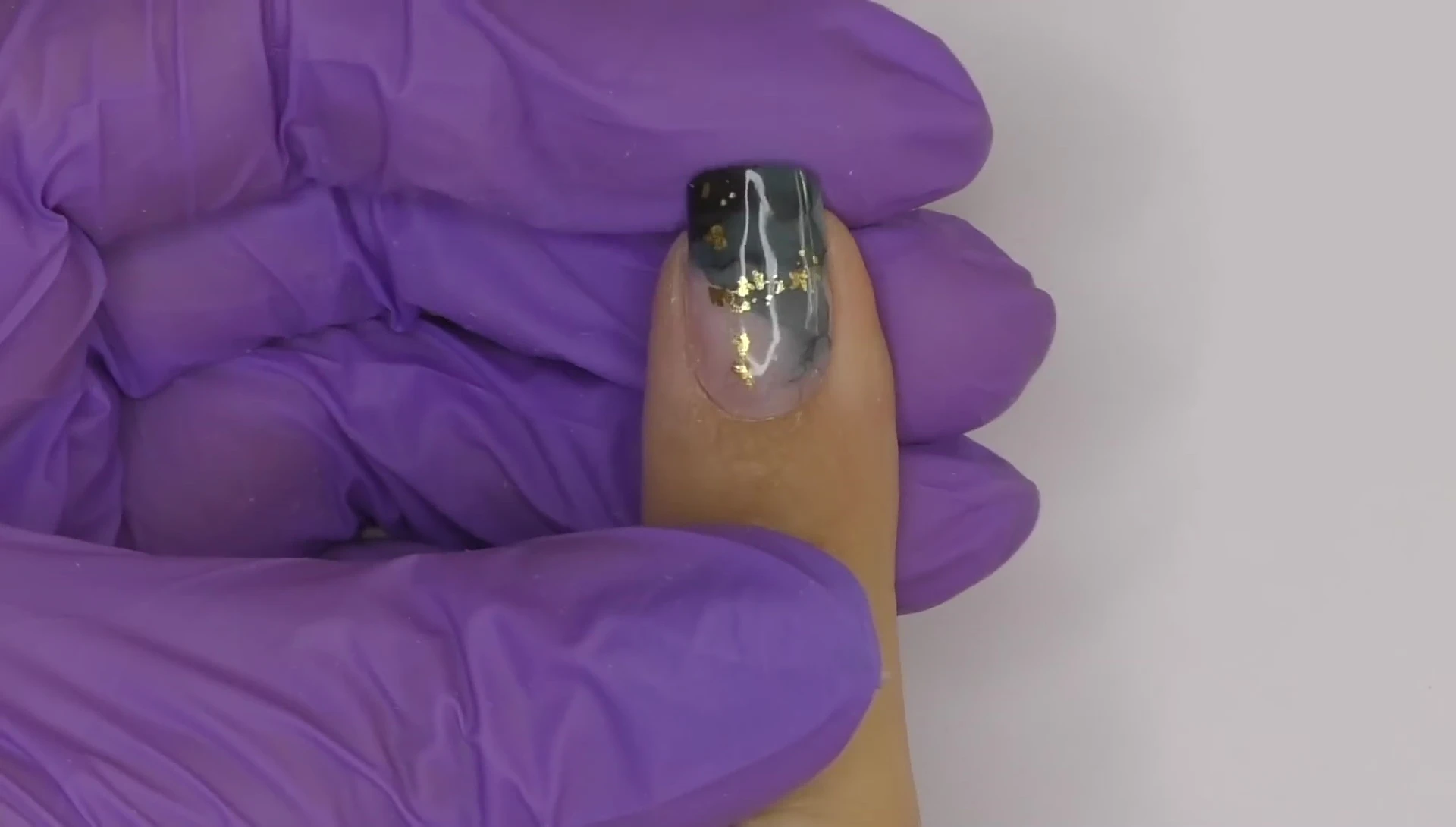 Applying gel nail strips for manicure