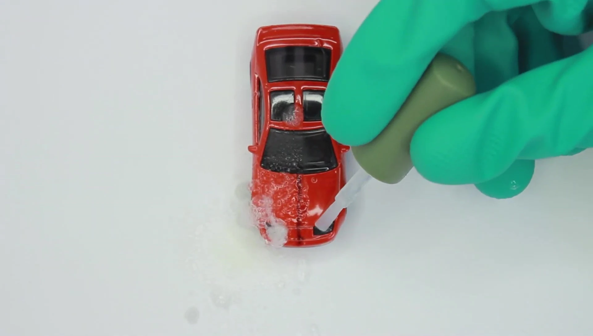 The toy car after application of the car paint stripper