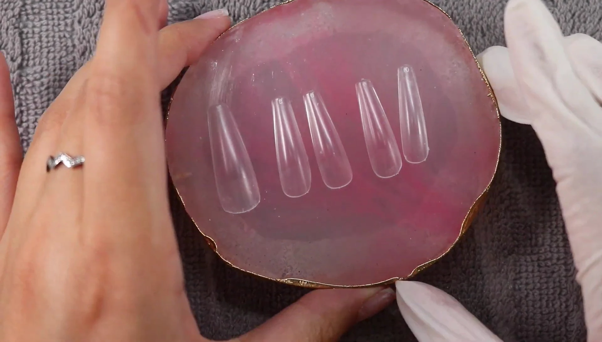 Nail tips on a pink tray