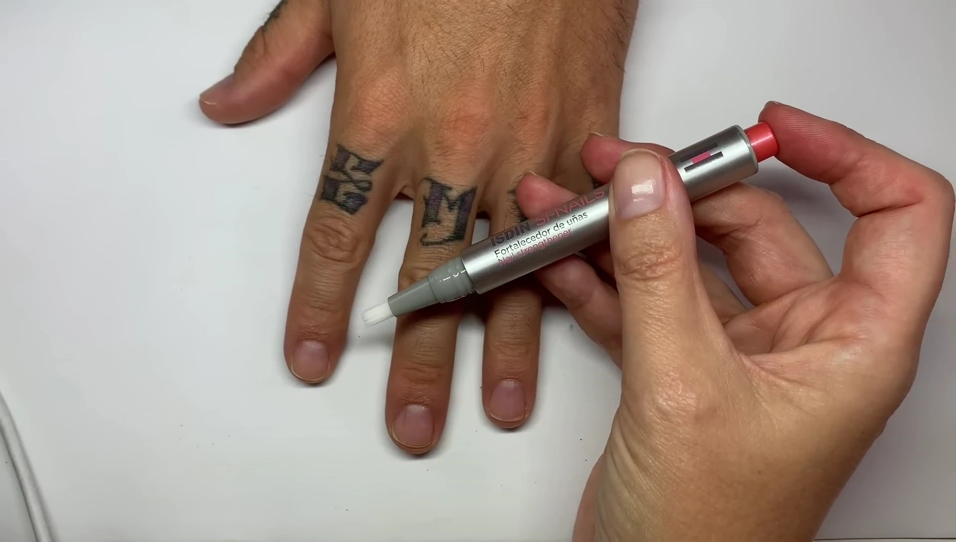 The product being applied to a nail