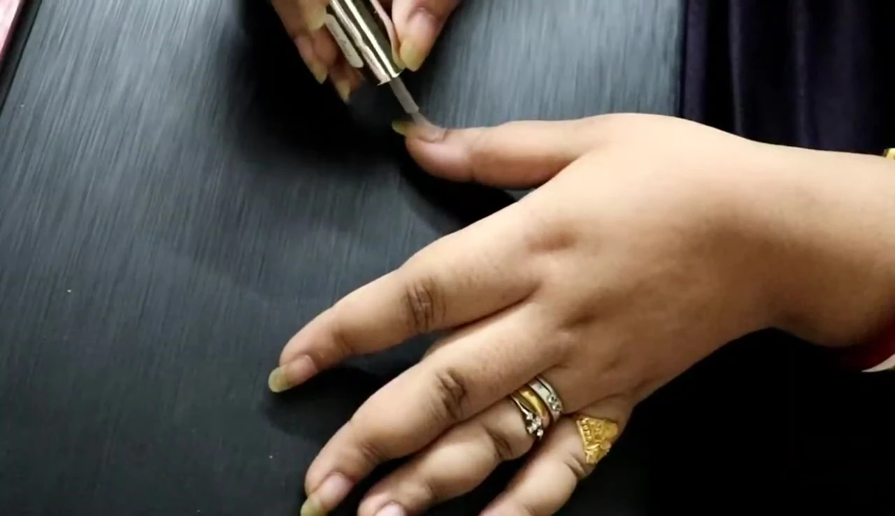 Applying base coat for nail stickers.