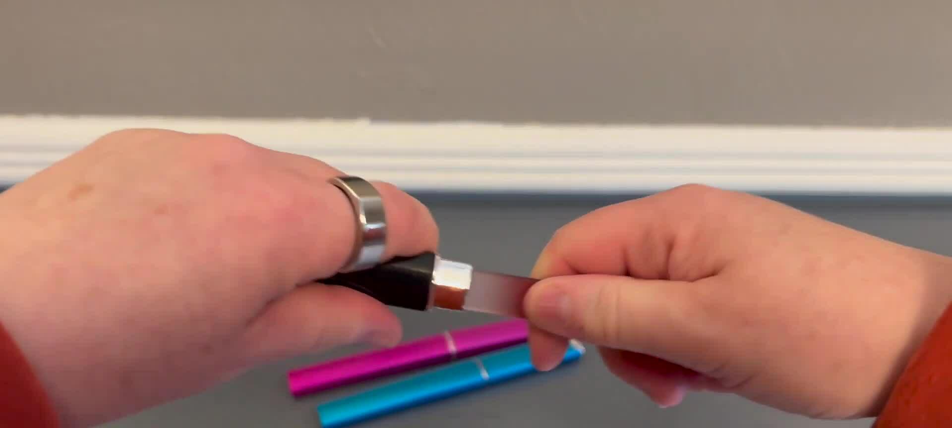A hand holding one of the nail files, showcasing its design.