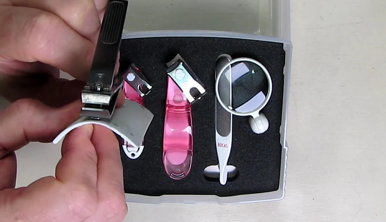 Close-up of traditional nail clippers showing the flat blade.