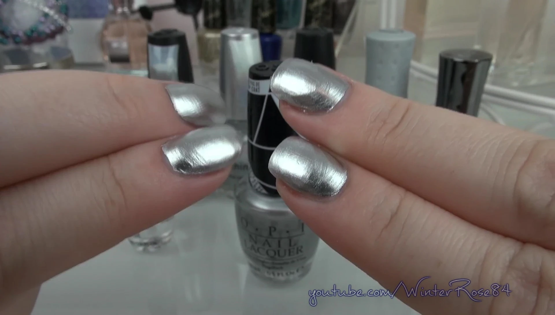 Comparison shot of nails with and without a top coat of polish.