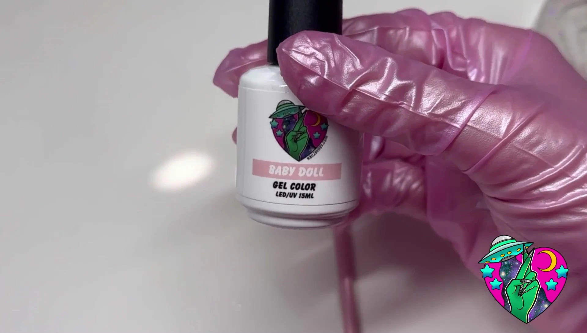 The liner brush being used to paint the outline of a Powerpuff Girl character.