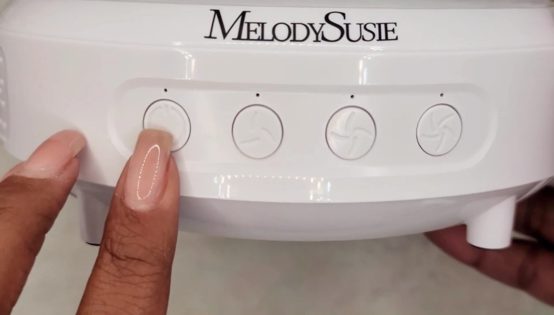 Close-up of the control panel with the power button and suction level settings.