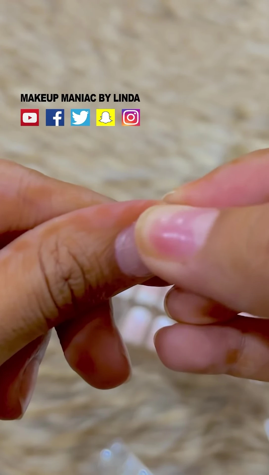 Close-up shot demonstrating false nail removal.