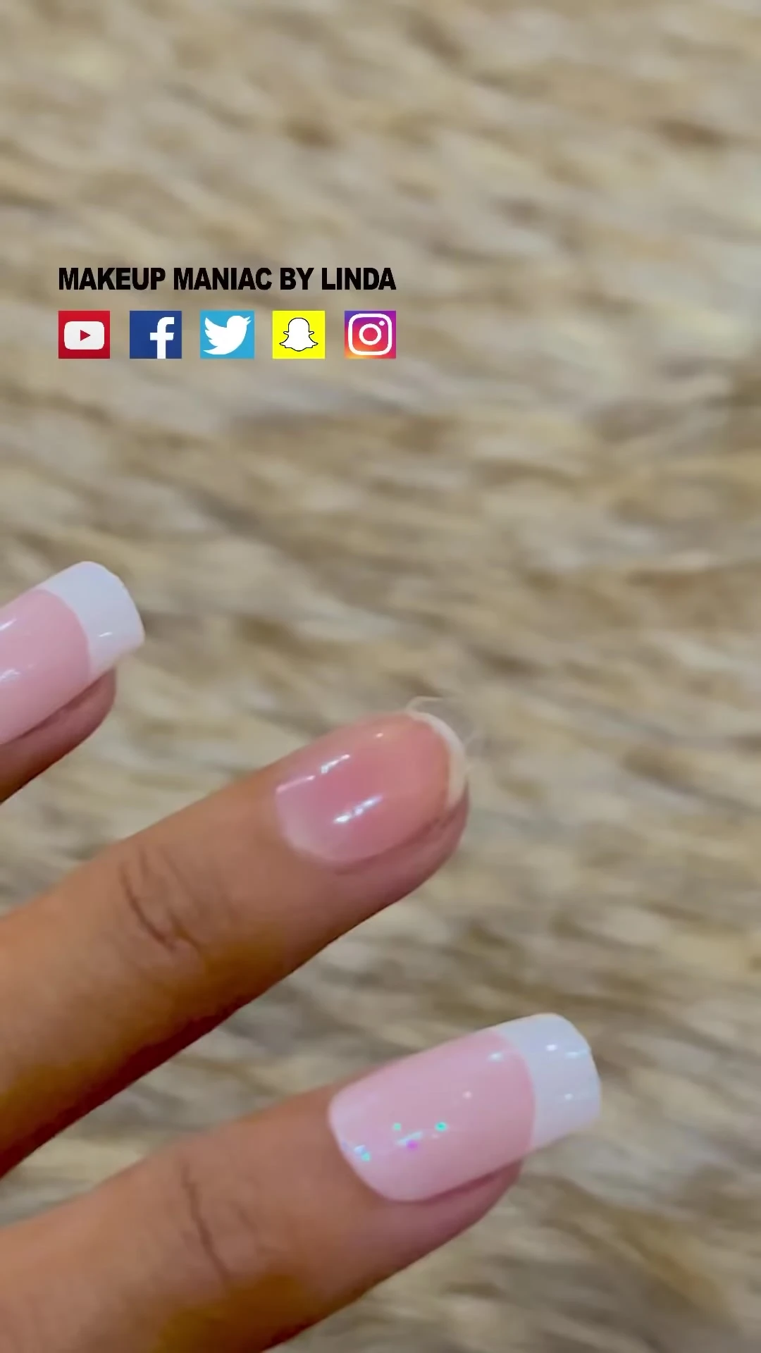 Close-up of a hand applying a false nail.