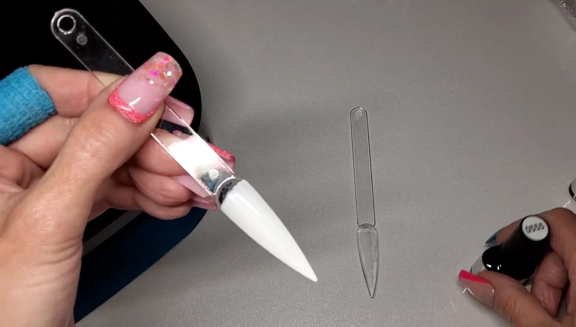 Applying a thick coat of white nail polish.