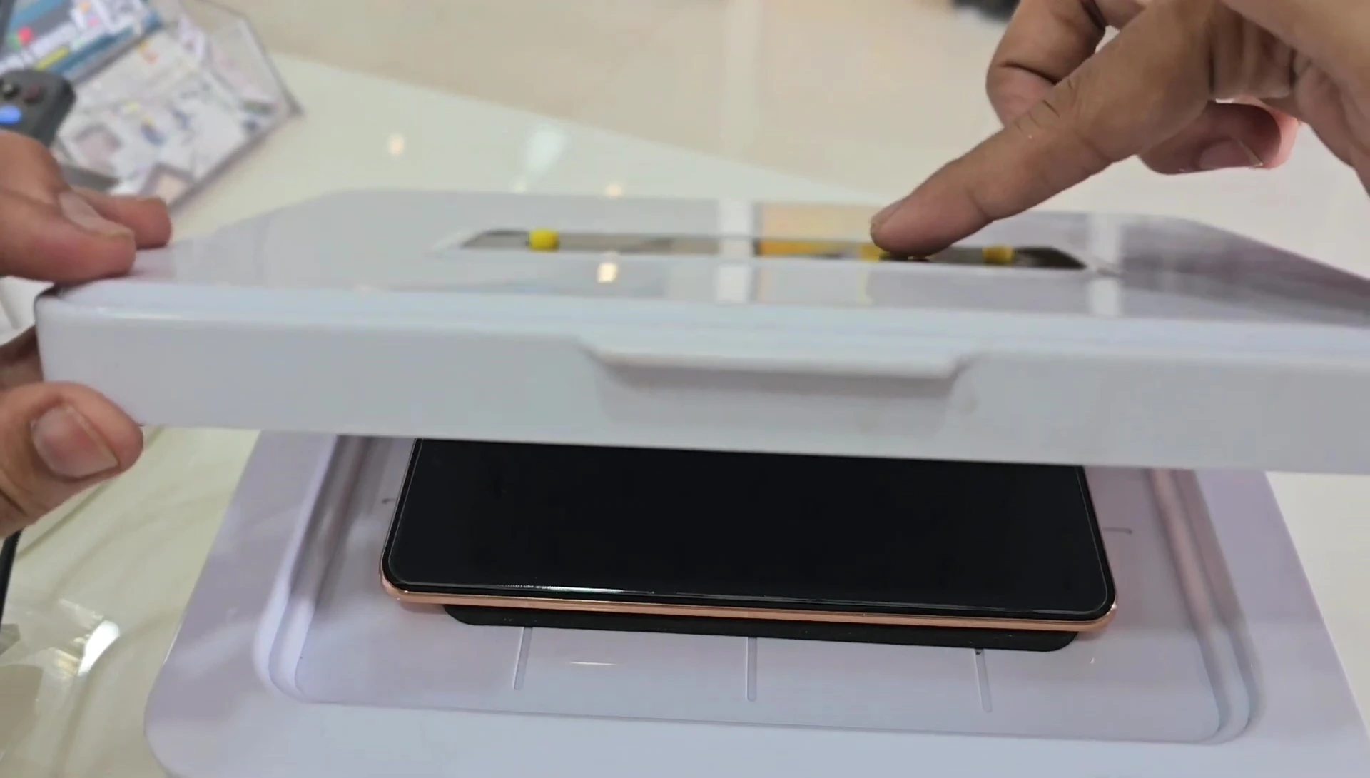 The UV light illuminating the screen protector.