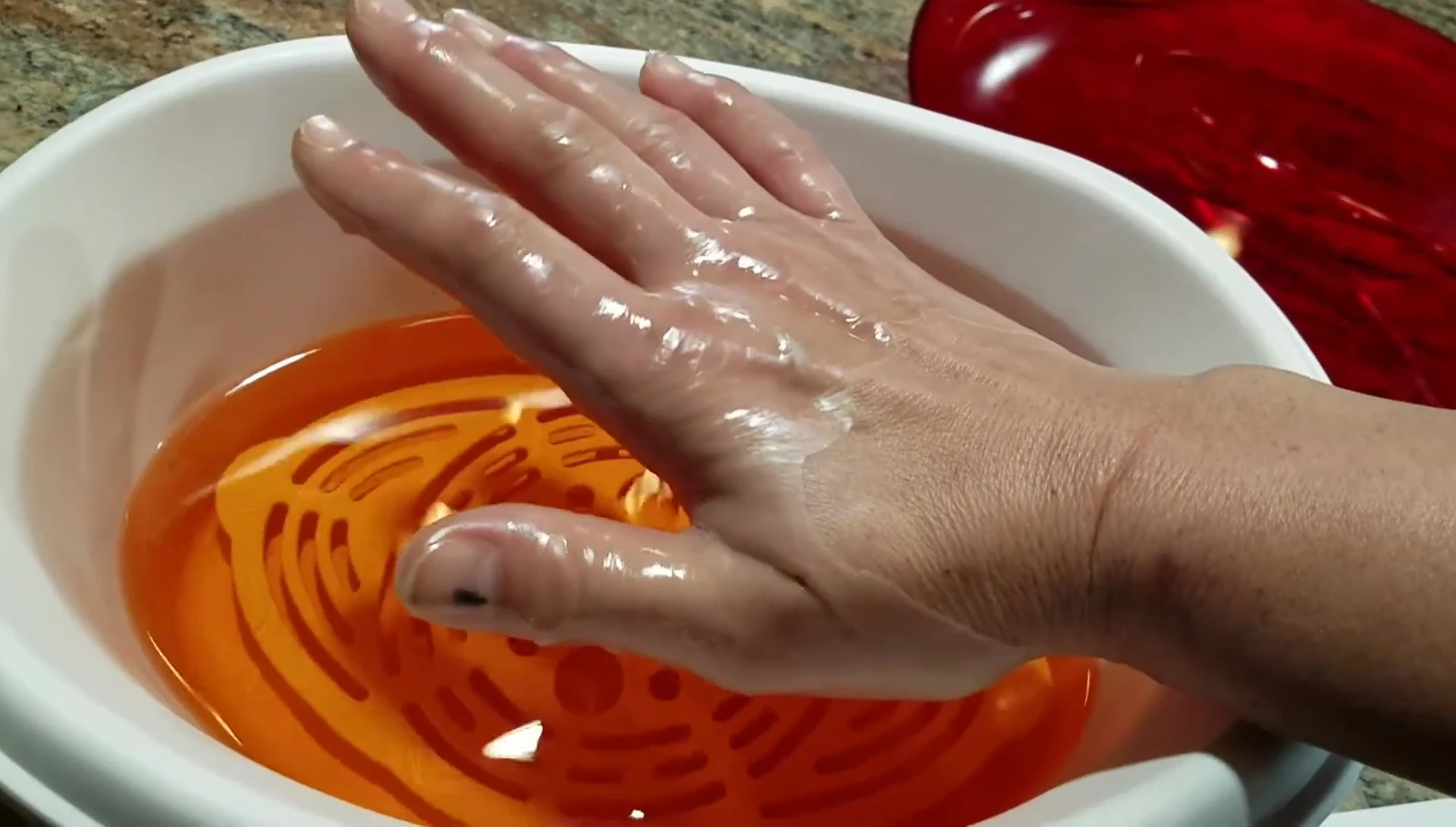 Hand coated with a layer of paraffin wax.