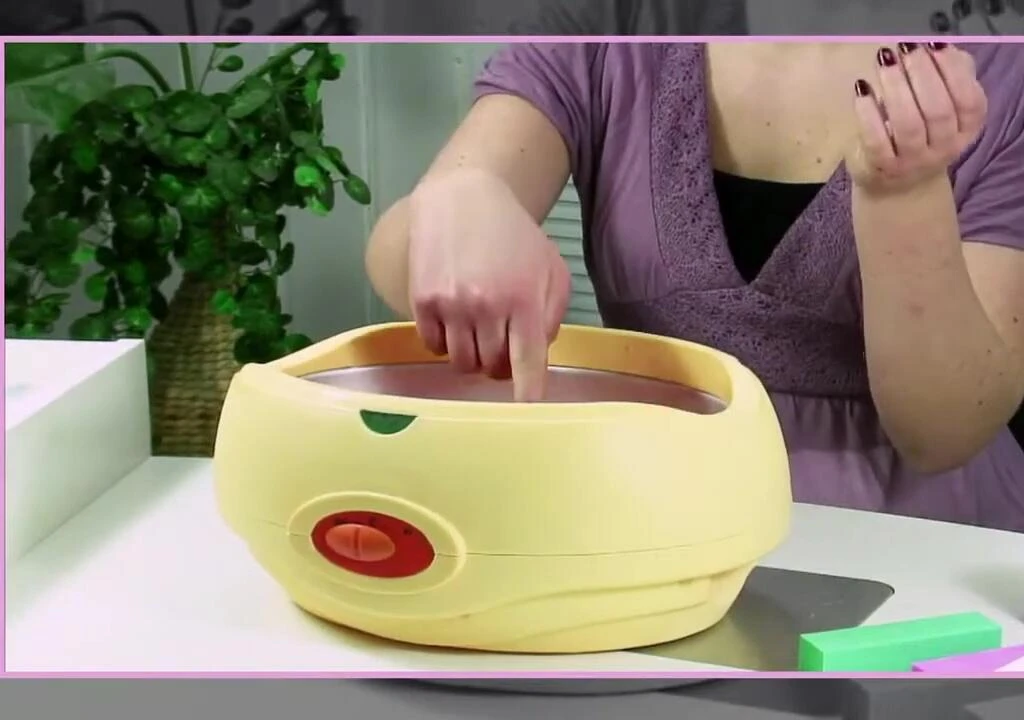 Testing the temperature of the paraffin wax on the wrist.