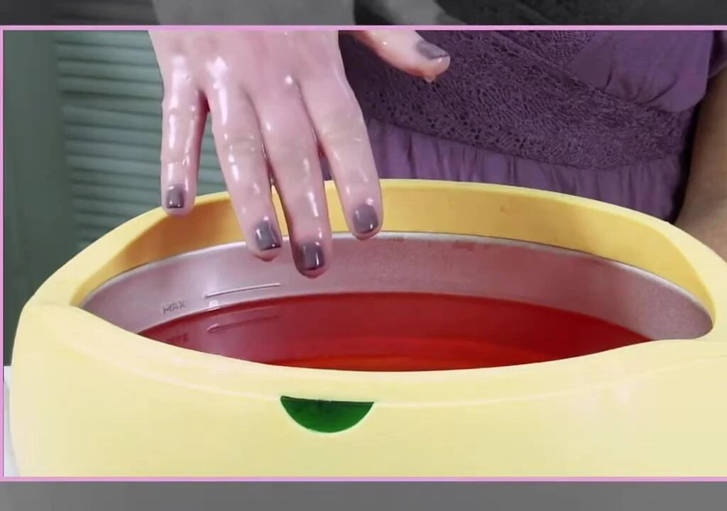 Hand being removed from the paraffin wax bath.