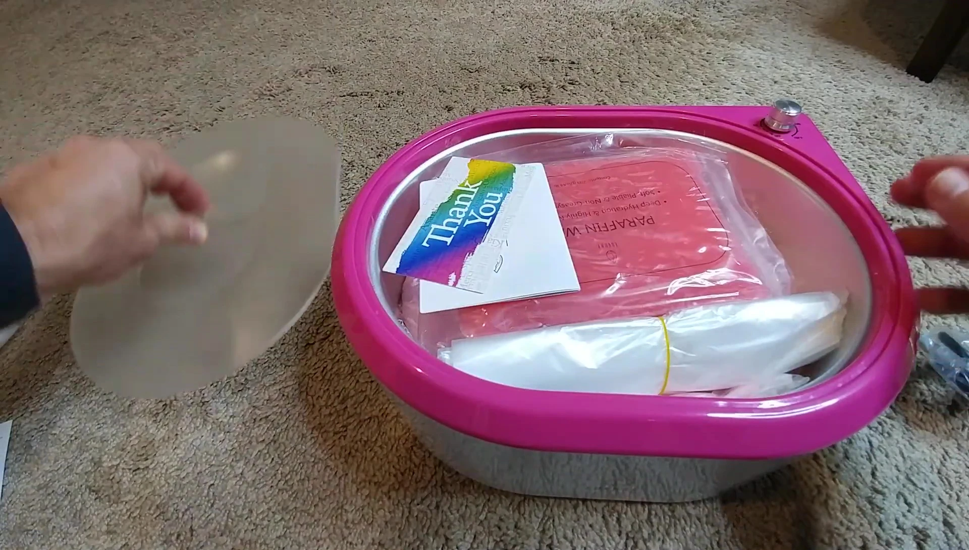 The contents of the box, including the paraffin warmer, wax bags, and accessories.