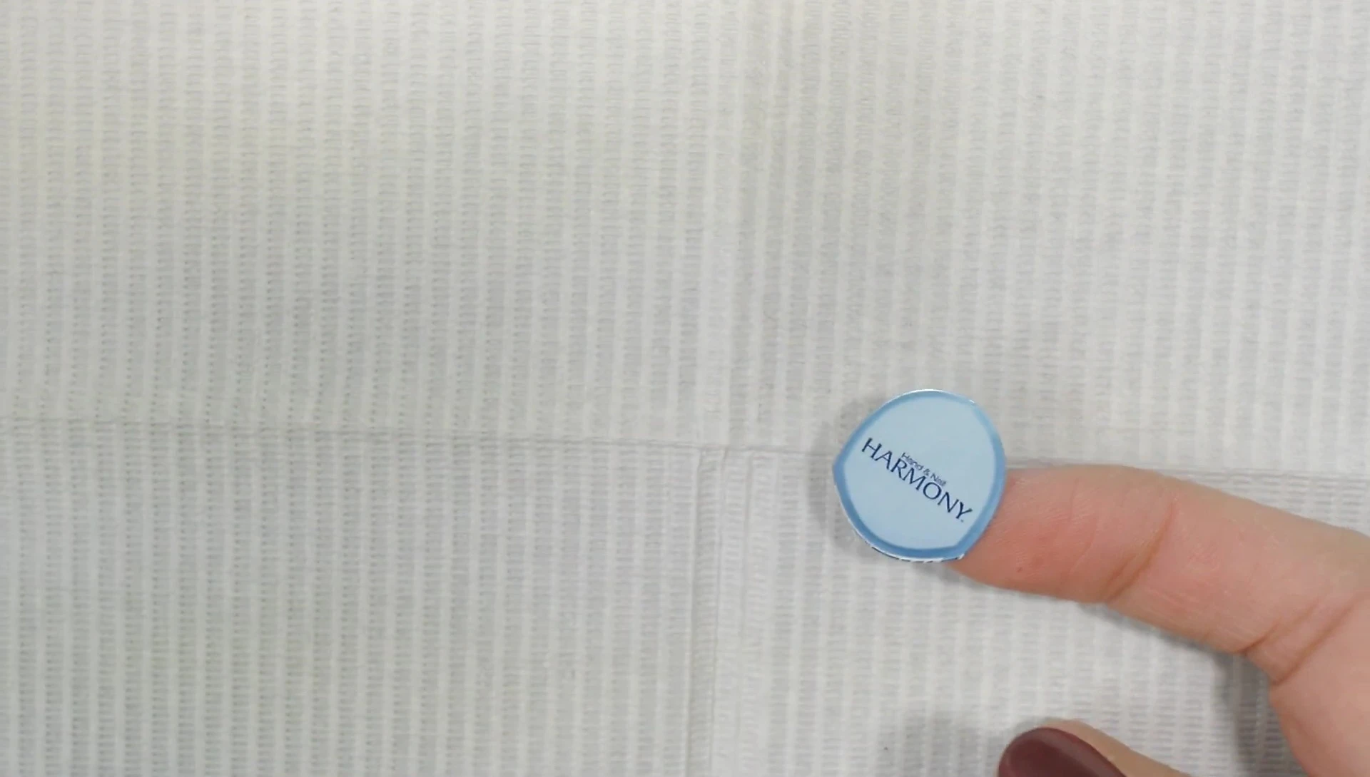 Demonstration of cutting and repositioning the middle sticker to create a straight edge.