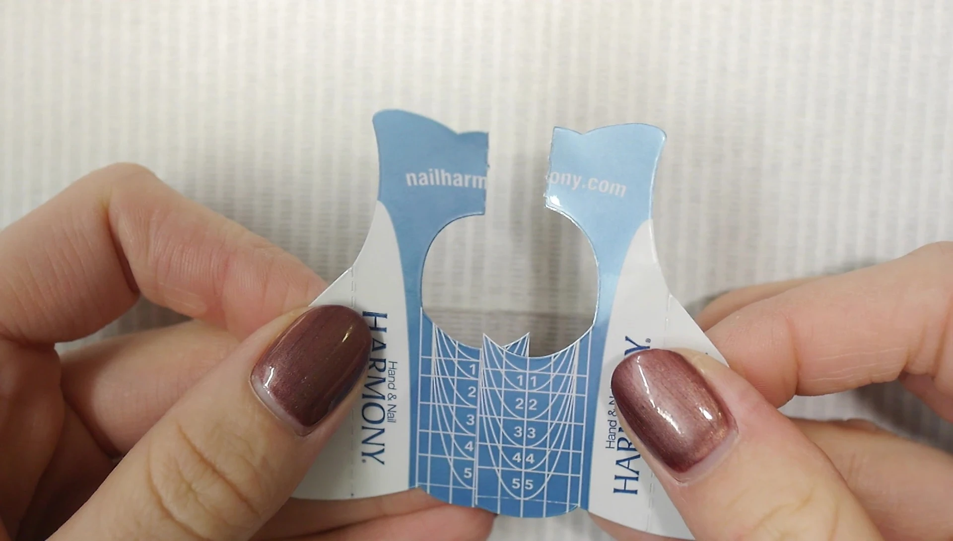 Overlapping and trimming the two nail forms to create a wider form.