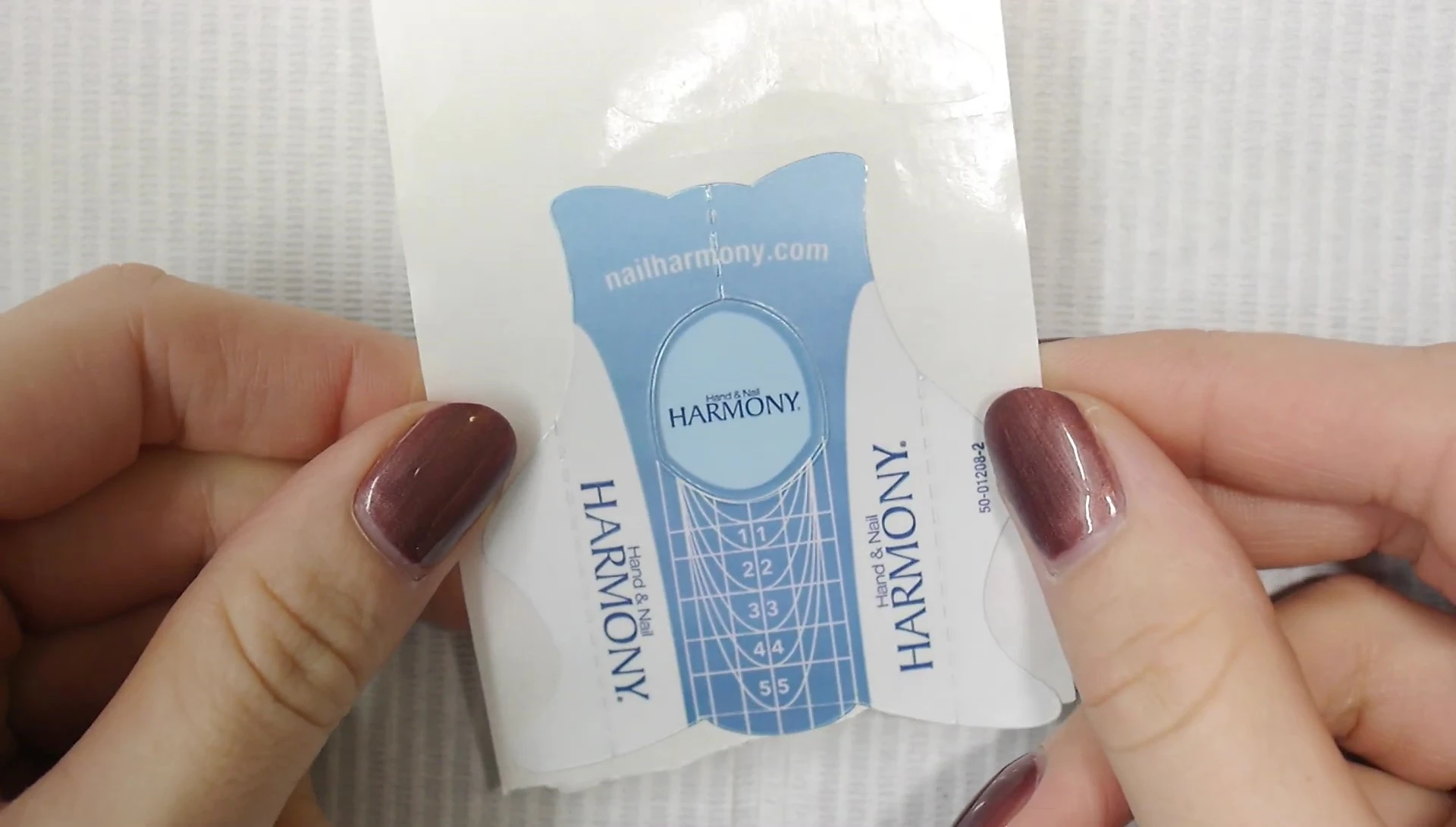Close-up of a nail with a deep smile line, highlighting the challenge of fitting a standard nail form.