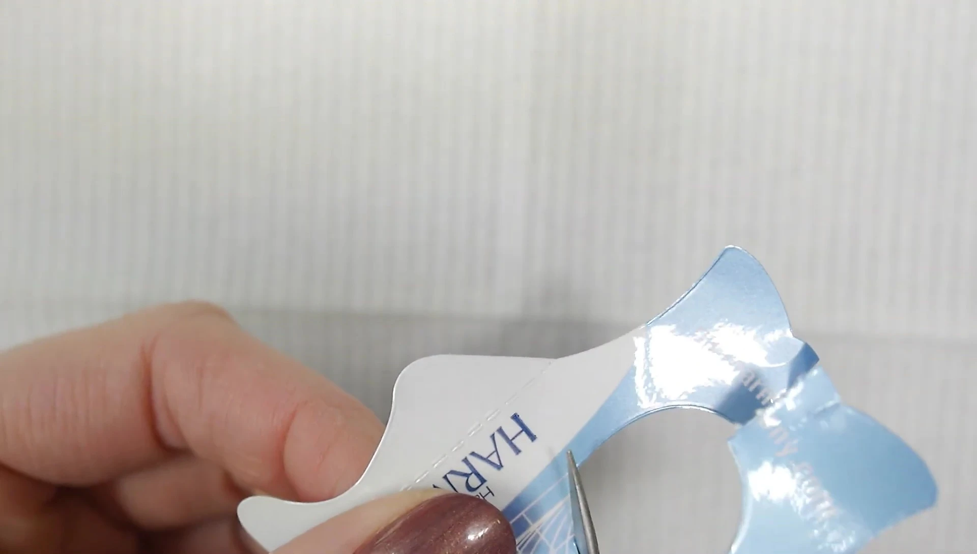 Demonstration of cutting a 'V' shape into the nail form.