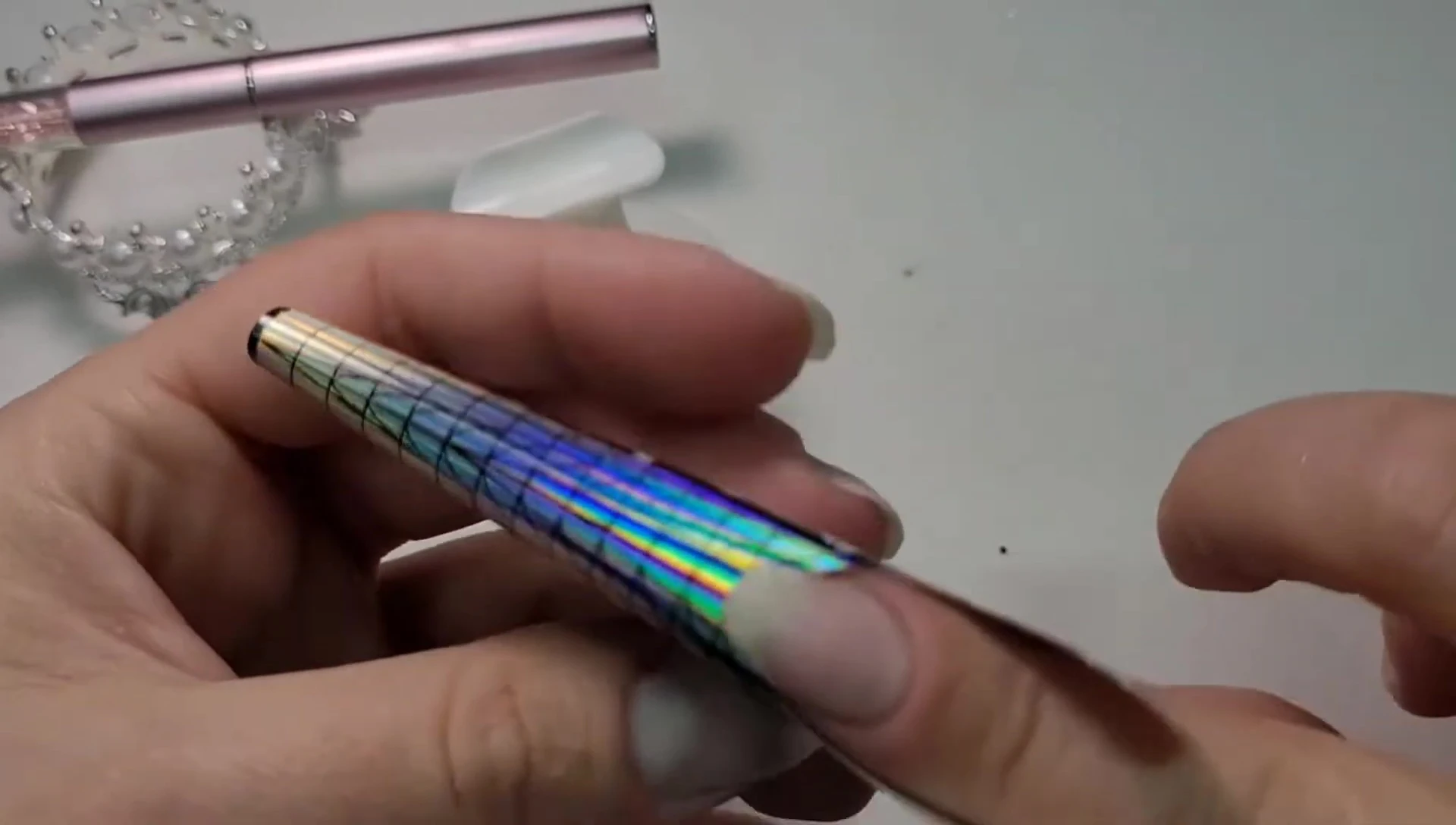 Showing the placement of the nail form on the finger, emphasizing the natural curve.