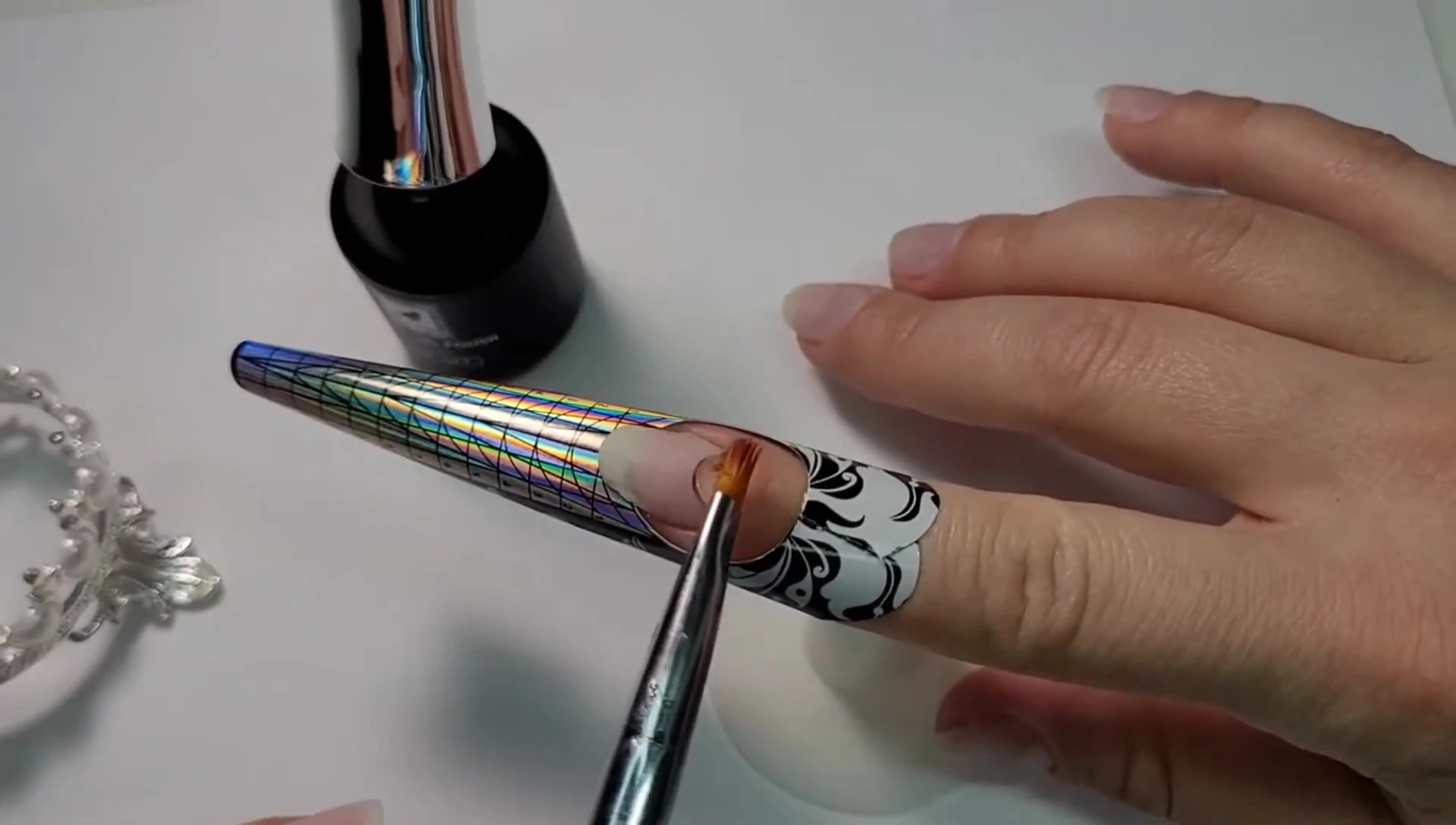 Demonstrating the initial application of builder gel, emphasizing the wiggling technique and starting point.