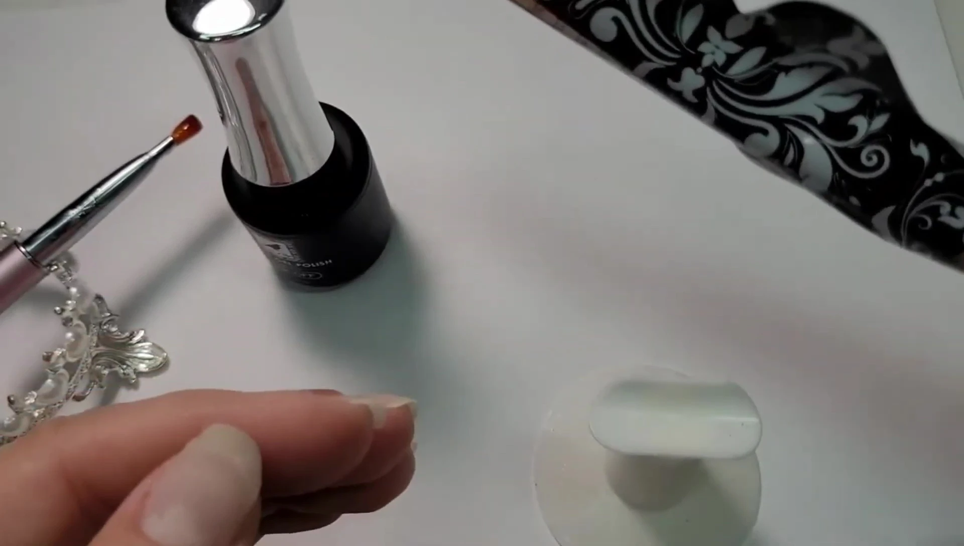 Illustrating the technique of flipping the hand to allow gravity to shape the nail.