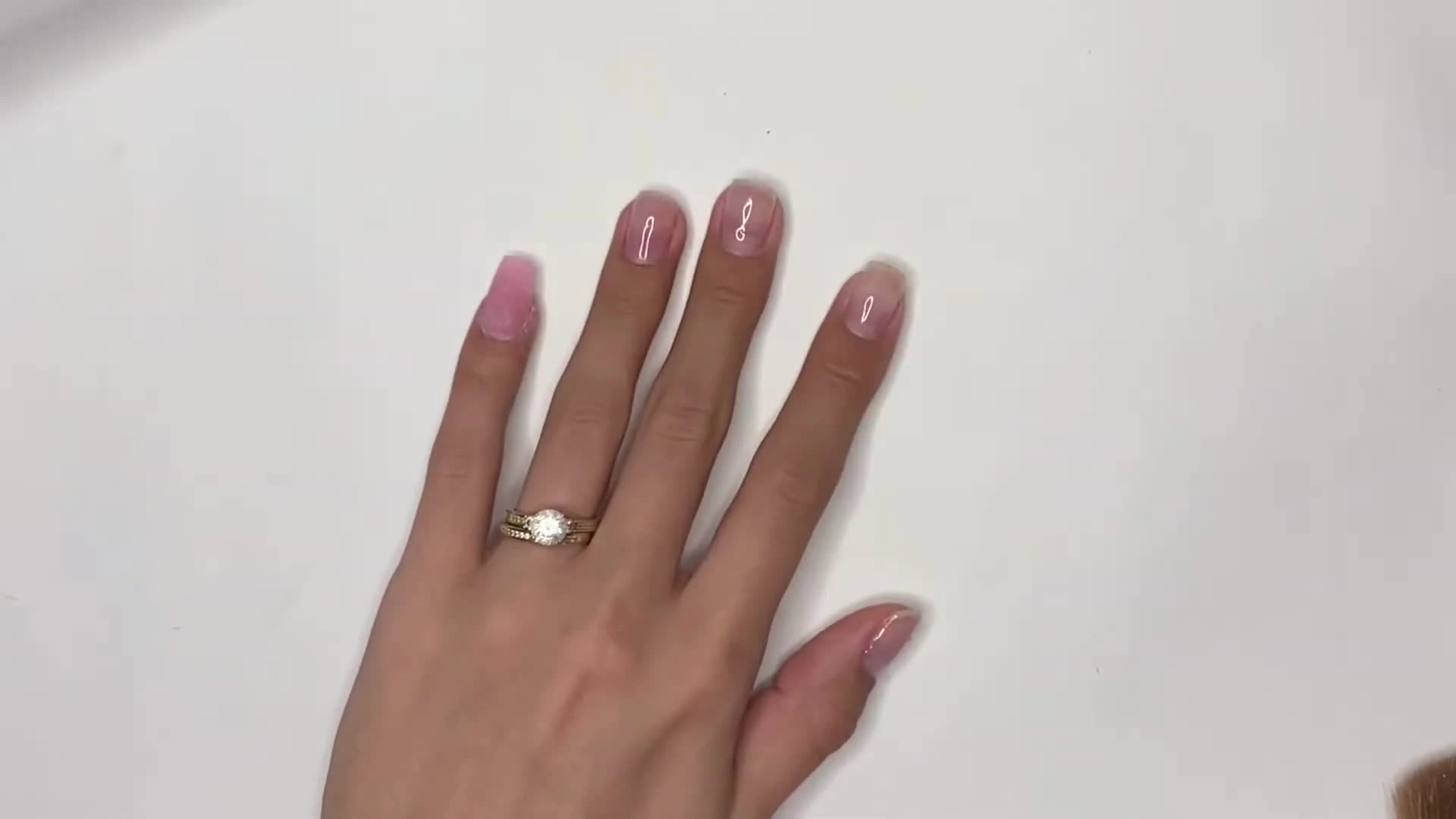 Application of base gel onto the prepared nails.