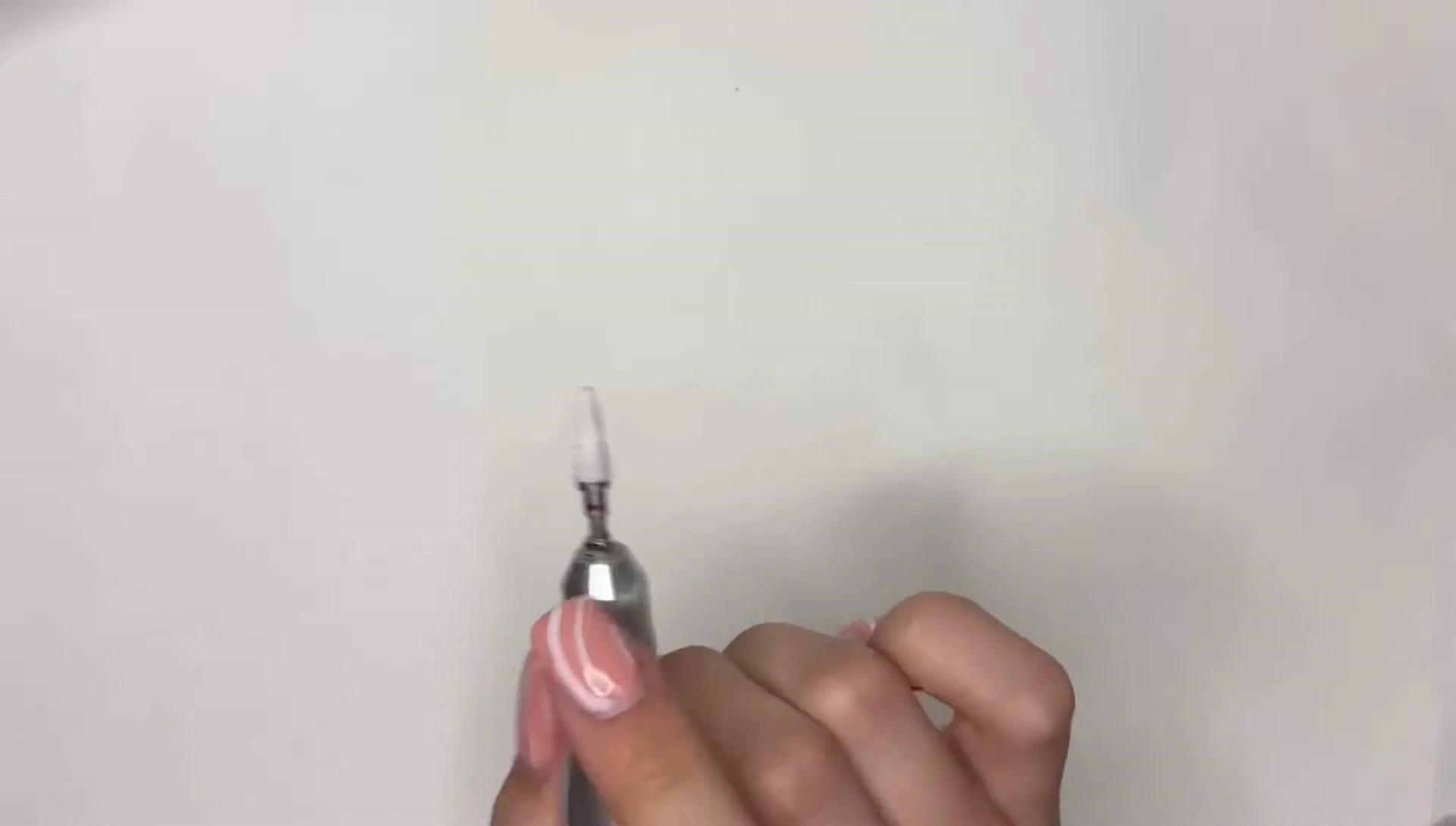 Filing and shaping the polygel extensions with an e-file.