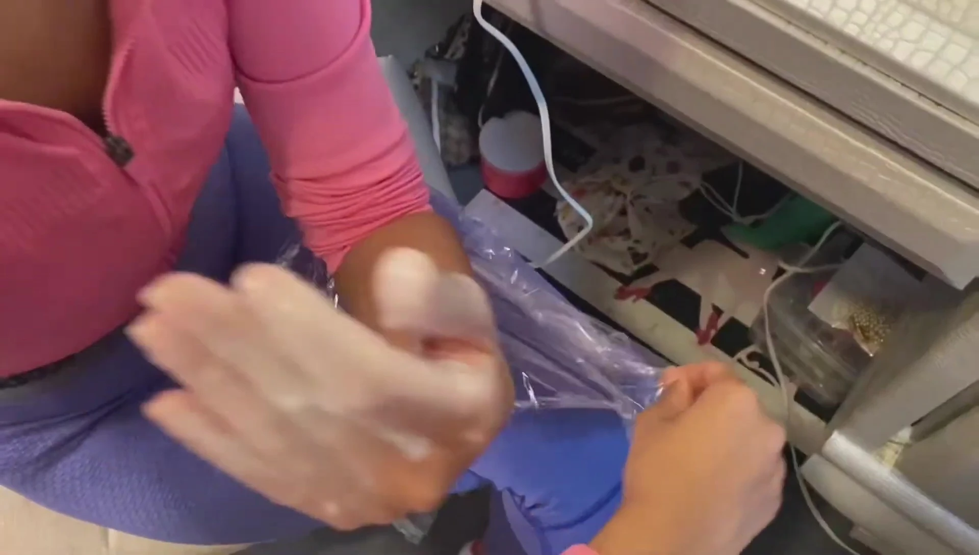 Hand wrapped in saran wrap after paraffin wax application